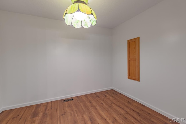 empty room with wood finished floors and baseboards