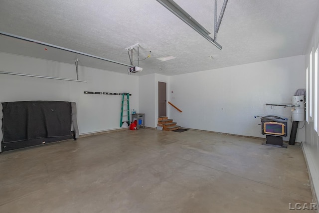 garage with a garage door opener and a wood stove