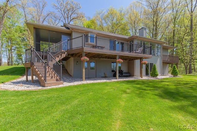 back of house featuring a wooden deck, a yard, stairs, and a chimney