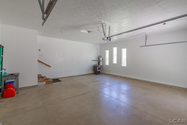 garage with a garage door opener and baseboards