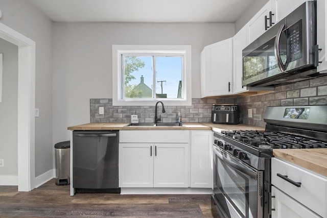 30 Palmer St NW, Grand Rapids, MI 49505 - kitchen with stainless steel appliances, wood counters, a sink, and backsplash