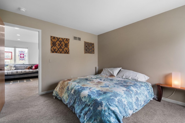 carpeted bedroom featuring baseboards