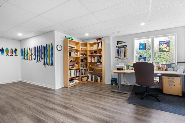 home office featuring wood finished floors, a paneled ceiling, baseboards, and recessed lighting