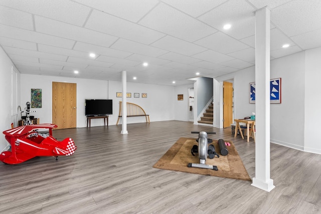 workout area featuring wood finished floors, baseboards, and recessed lighting