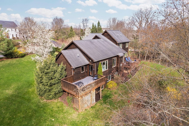 back of house featuring a deck and a lawn