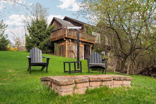 rear view of house featuring a deck and a yard