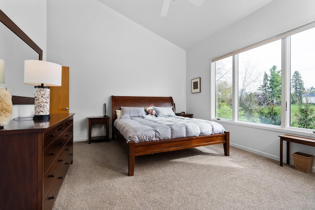 bedroom featuring light carpet, baseboards, high vaulted ceiling, and a ceiling fan