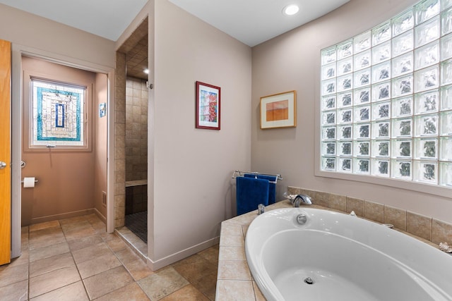 bathroom featuring a bath, baseboards, tiled shower, and recessed lighting