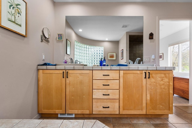 full bathroom with double vanity and recessed lighting