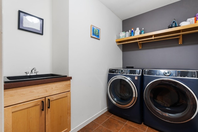 laundry room with cabinet space, separate washer and dryer, dark tile patterned floors, and baseboards
