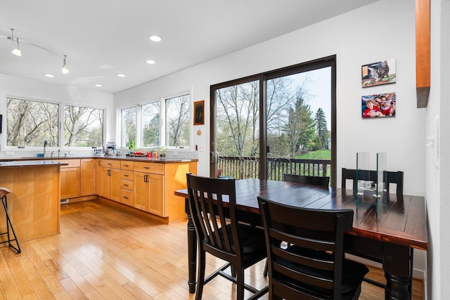 dining room with light wood-type flooring and recessed lighting