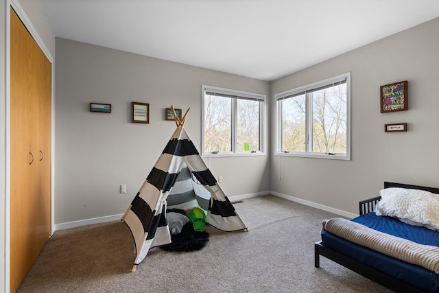 bedroom featuring carpet flooring and baseboards