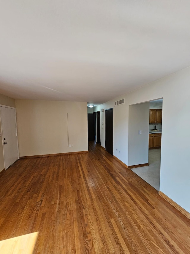 empty room with wood finished floors and baseboards