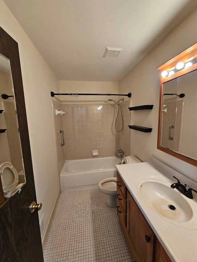 bathroom featuring toilet, vanity, and  shower combination