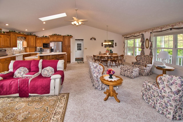 2688 White St, Niles, MI 49120 - living area featuring light carpet, vaulted ceiling, ceiling fan, a chandelier, and a skylight