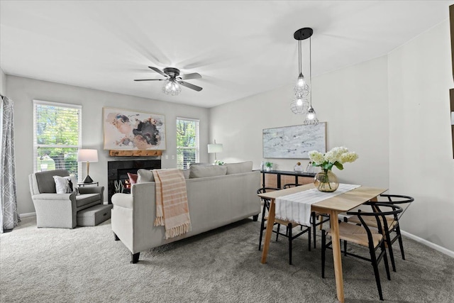 5949 High Point Ct, Brighton, MI 48116 - carpeted dining area featuring ceiling fan, plenty of natural light, baseboards, and a fireplace