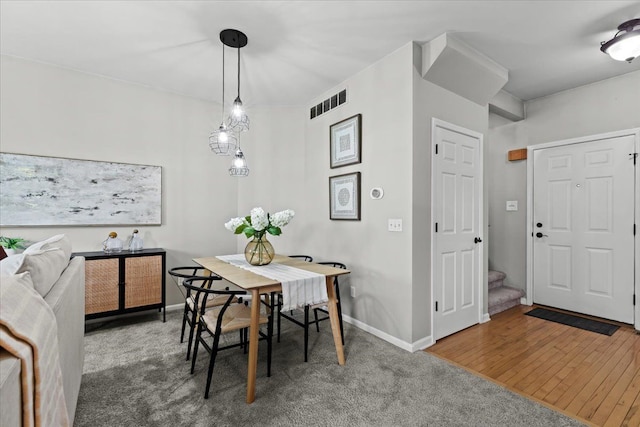 5949 High Point Ct, Brighton, MI 48116 - dining space featuring carpet flooring, baseboards, and stairway