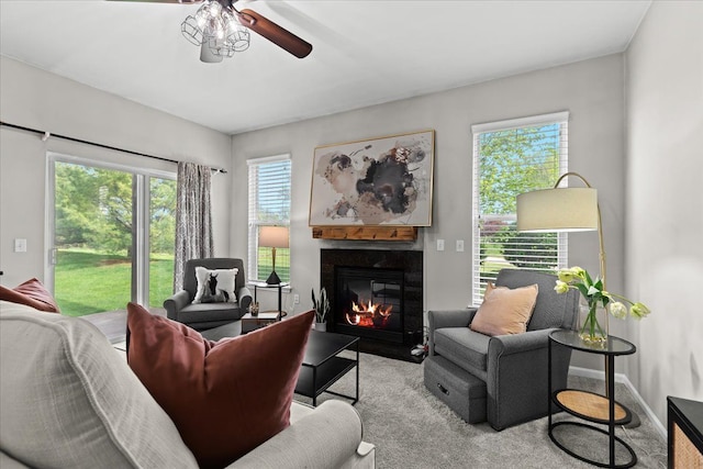 5949 High Point Ct, Brighton, MI 48116 - carpeted living area with a ceiling fan and a fireplace with flush hearth