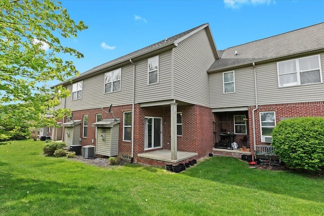 5949 High Point Ct, Brighton, MI 48116 - rear view of house with central AC unit, a lawn, and brick siding
