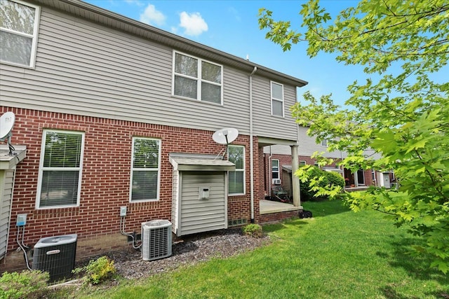 5949 High Point Ct, Brighton, MI 48116 - back of property featuring central AC unit, a yard, and brick siding