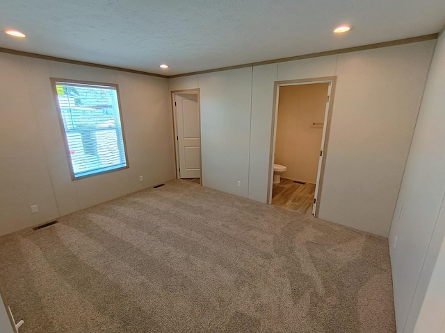 1204 Carlton Ct, Plainwell, MI 49080 - unfurnished bedroom with carpet floors, recessed lighting, connected bathroom, ornamental molding, and a textured ceiling