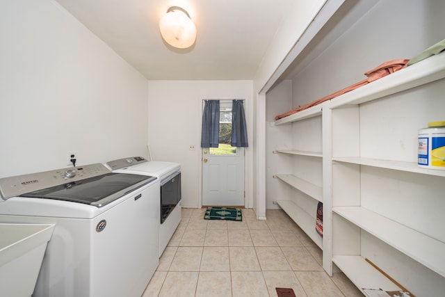 washroom with independent washer and dryer and light tile patterned floors