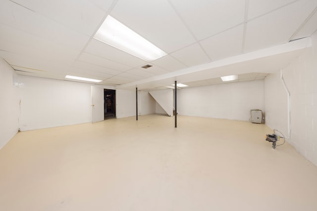 finished below grade area featuring a drop ceiling