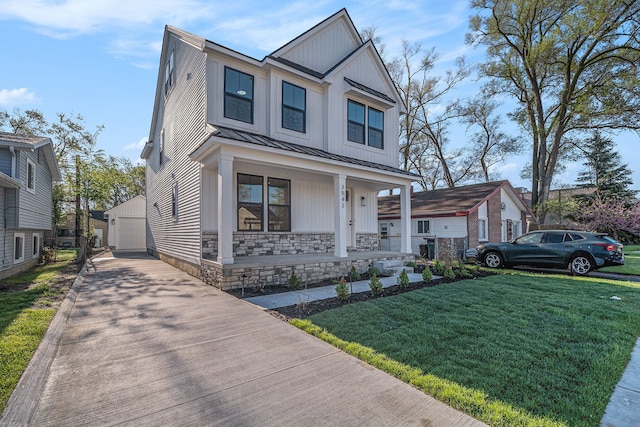 3542 Royal Ave, Berkley, MI 48072 - view of front facade featuring a porch, a standing seam roof, an outdoor structure, a front lawn, and a detached garage