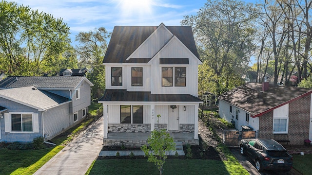 3542 Royal Ave, Berkley, MI 48072 - view of front facade with covered porch, board and batten siding, driveway, metal roof, and a standing seam roof