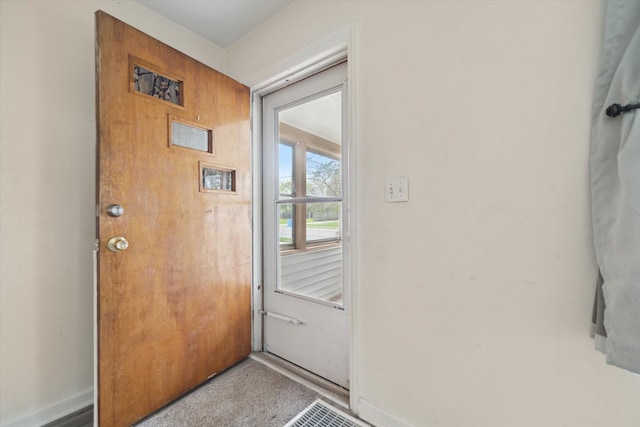 doorway to outside featuring baseboards