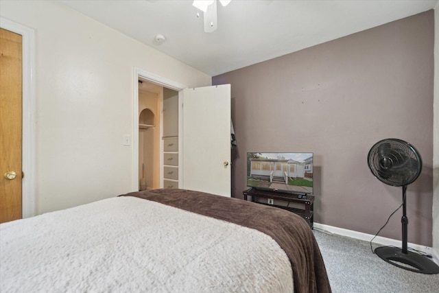 carpeted bedroom featuring baseboards and ceiling fan