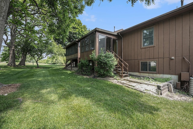 3217 Westminster Dr SE Unit 69, Grand Rapids, MI 49512 - view of grassy yard with a sunroom and stairs