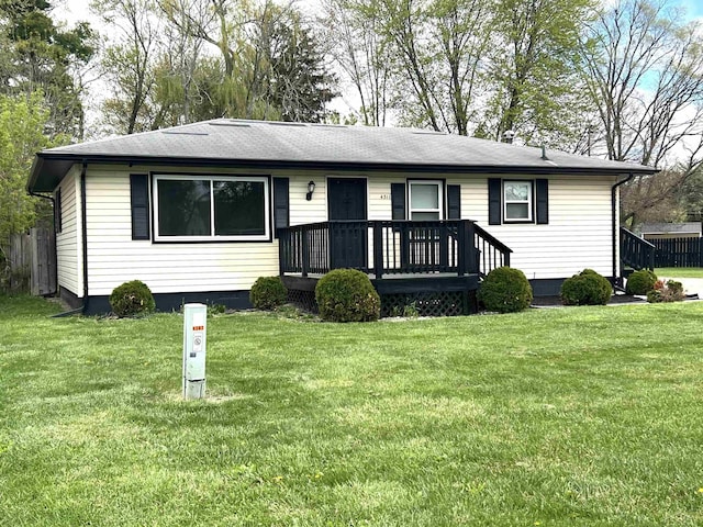 single story home featuring a front lawn, crawl space, roof with shingles, and a wooden deck