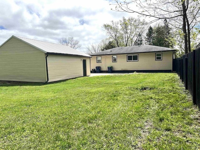 rear view of property featuring a patio and an outdoor structure