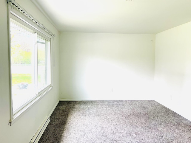 carpeted empty room featuring baseboards and baseboard heating