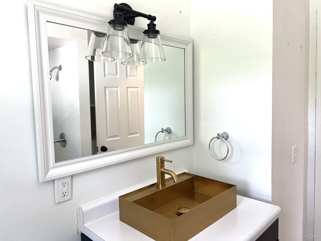 bathroom with a chandelier and vanity