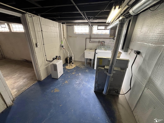below grade area with washer / clothes dryer and a sink
