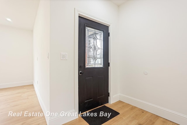 entrance foyer featuring light wood-style flooring and baseboards