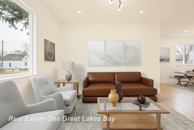 living room featuring wood finished floors, baseboards, and recessed lighting