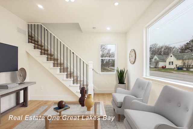 living room featuring stairs, wood finished floors, recessed lighting, and baseboards