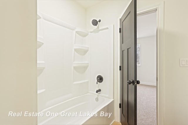 bathroom featuring shower / bath combination and baseboards