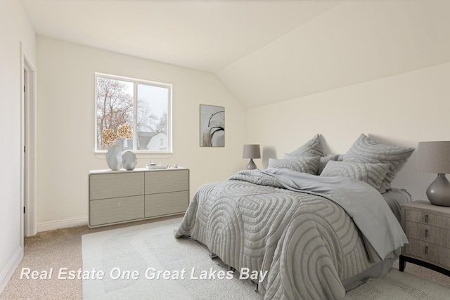 bedroom featuring baseboards, light carpet, and vaulted ceiling