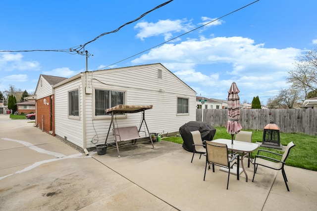 back of property featuring a patio area and outdoor dining space