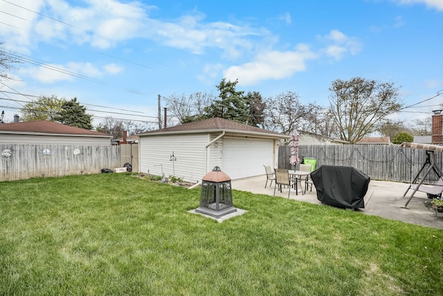 view of yard featuring a detached garage and a patio area