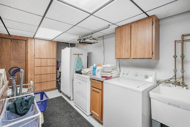 clothes washing area with cabinet space and washer and dryer