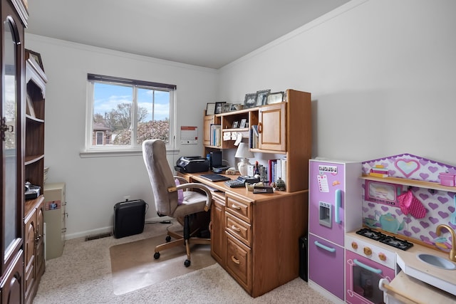 home office with a sink, crown molding, light colored carpet, and baseboards