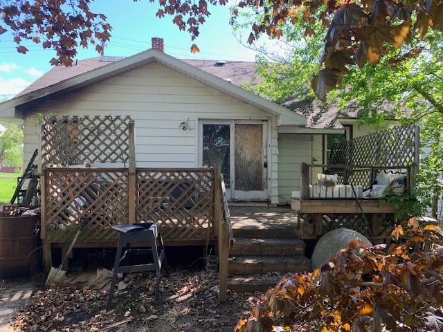 back of house with a deck