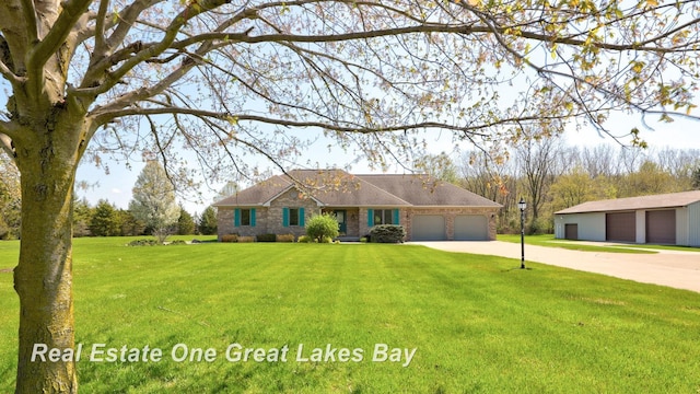 single story home with driveway, a front yard, brick siding, a shingled roof, and a detached garage