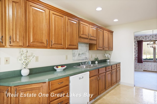kitchen with a sink, dishwasher, brown cabinetry, recessed lighting, and dark countertops