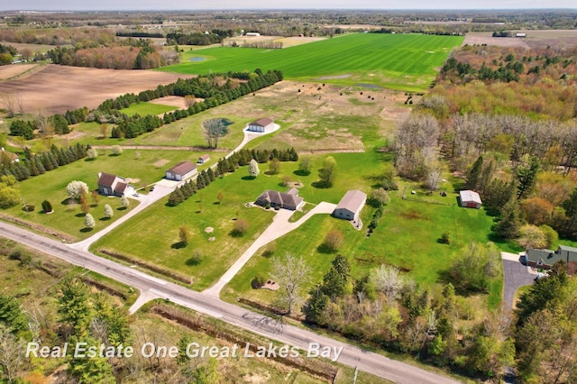 aerial view of property and surrounding area featuring rural landscape